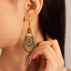 Vintage bohemian drop earrings with resin beads and colorful tassels on model