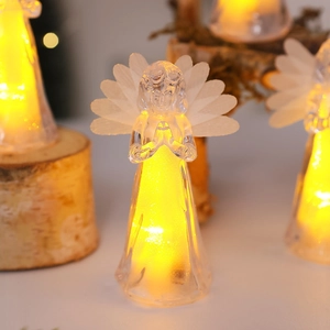 Close-up of LED glowing acrylic angel ornament with warm light and sparkling glitter