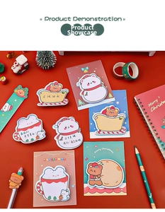Macro detail of Christmas themed bear and snowman sticky notes on a festive red background