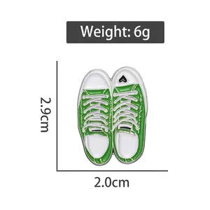 Creative green canvas shoe enamel pin badge with heart detail and dimensions shown