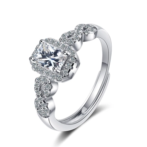 Silver square-cut halo ring with side stone accents and adjustable band on white background