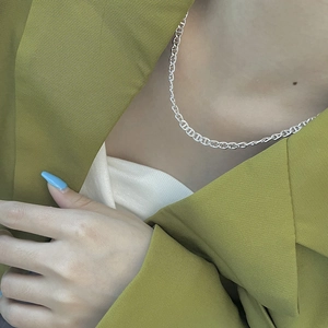 Chic 925 sterling silver pig nose link necklace shown on a model neck with green blazer