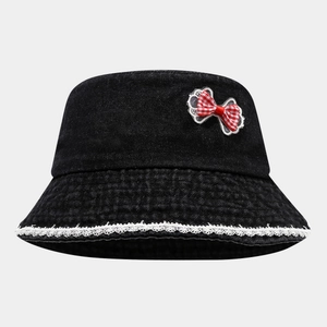 Detail of black denim bucket hat with red checkered bow and white lace brim decoration