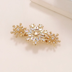 Close-up of golden snowflake hair clip with colorful crystals and sparkling rhinestones