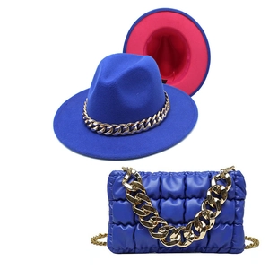 Detail of royal blue fedora with gold chain and matching quilted bubble leather bag