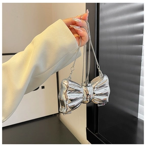 Mini silver metal evening bag with bow design and sleek chain strap for women