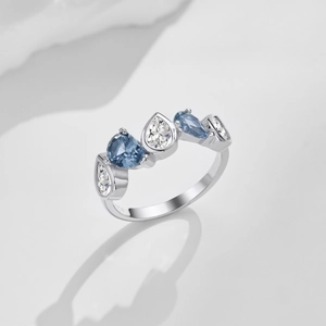 Macro detail of S925 silver ring featuring blue and white pear-cut zircon heart stones