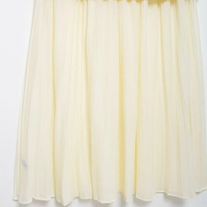 Elegant pale yellow pleated midi skirt for women with high-quality chiffon texture