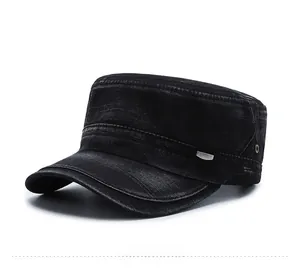 Detail of black washed denim military cap with metal sport badge and ventilation eyelets