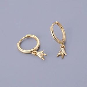 Detailed close-up of gold-plated S925 silver huggie earrings with rock hand charm