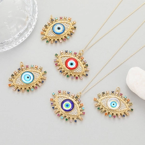 Colorful evil eye necklaces with vibrant zircons and gold pendants on stone decor