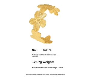 Detailed macro view of 18K gold plated stainless steel floral cuff bracelet TXZ178