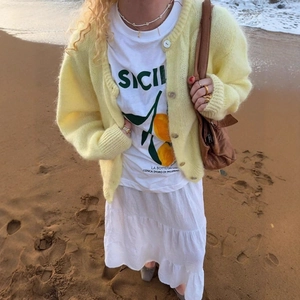Women's yellow knit cardigan with Sicily t-shirt and white pleated skirt beach outfit