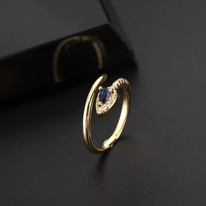 Bohemian gold plated snake ring with a pear-cut blue sapphire and CZ pavé detail