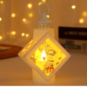 Close-up of white LED Christmas lantern with warm light and snowman print on a desk