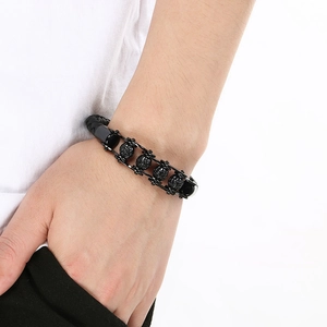 Detailed view of skull bead and braided leather on a vintage punk stainless steel bracelet