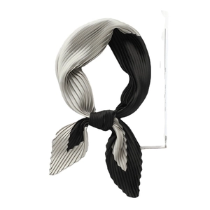 Elegant black and white pleated silk scarf featuring a minimalist two-tone patchwork design