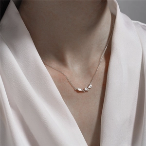 Close-up of 925 sterling silver necklace with marquise zircon cluster on a female model