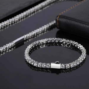 Macro shot of silver tennis necklace with round-cut white zircons and box clasp closure