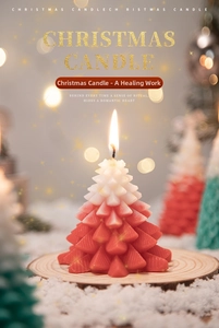 Detail of red and white gradient Christmas tree candle on a round wooden tray