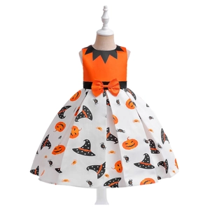 Close-up of Halloween girl dress featuring pumpkin prints and orange bow detail