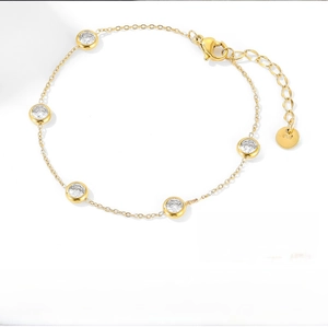 Detail of gold titanium steel bracelet with five round cubic zirconia stones and extender