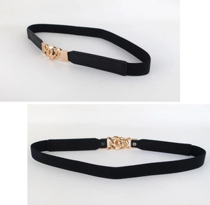 Detail view of black elastic waist belt featuring a decorative gold interlocking metal buckle
