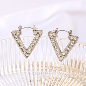 French style V-shaped titanium steel earrings with crystals on a textured glass plate