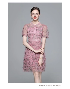 Détails de la robe en dentelle florale rose avec col perlé et volants superposés