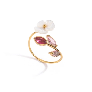 Macro shot of gold floral ring with pink crystals and white mother of pearl petal