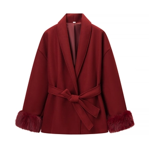Detail of burgundy wool coat showing elegant tied waist belt and plush faux fur cuffs