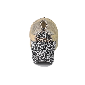 Detail view of the ponytail hole and leopard print mesh on a washed baseball cap