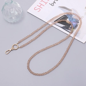 Detailed view of champagne crystal beaded phone strap with gold metal lobster clasps