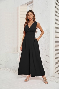 Detail of black V-neck sleeveless jumpsuit showing waist design and wide-leg cut with side pocket