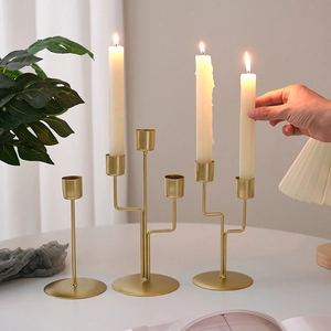Modern gold iron candle holders in varying heights for romantic dining table decor