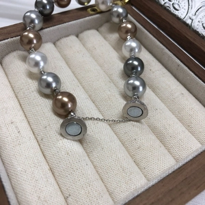 Close-up of pearl bracelet with magnetic buckle in a luxurious wooden jewelry box