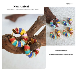 Close-up of colorful enamel hoop earrings with gold plating and vibrant geometric color blocks