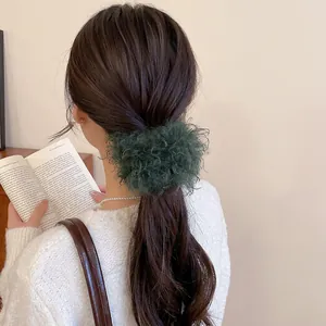 Elegant dark green plush hair scrunchie with soft faux fur texture for a warm autumn look