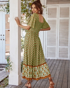 Detailed shot of green floral pattern and square neckline on a maxi summer dress