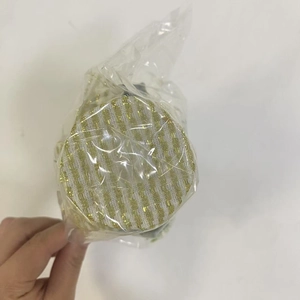Detailed view of mini Christmas ornament wrapped in protective plastic packaging