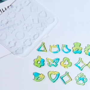 Detail of 20-cavity silicone mold with flower and geometric resin earring pendants