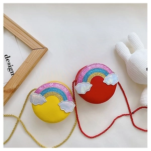 Flat lay of colorful rainbow crossbody bags for kids in vibrant yellow and red styles