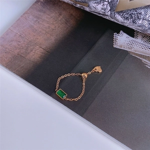 Adjustable gold chain ring with emerald green zircon stone and small heart charm