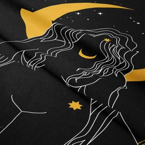 Detail of bohemian tapestry fabric with moon and celestial woman silhouette print