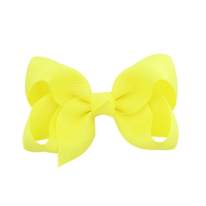 Detailed close-up of a 4-inch yellow grosgrain ribbon bow hair clip with ribbed texture