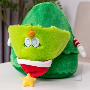 Detail of green Christmas tree plush toy with cute embroidered eyes and star pendant
