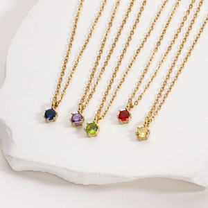 Detailed macro view of heart zircon pendants in five colors on 18K gold-plated chains