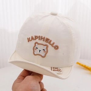 Detail of baby sun hat featuring embroidered bear face and soft brim in cream white
