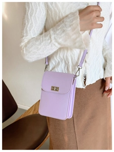 Close-up of lavender crossbody phone bag with silver metallic twist lock and cross-grain leather