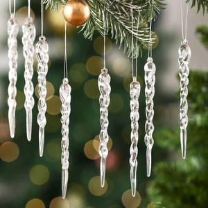 Macro detail of transparent spiral icicle ornaments hanging on a Christmas tree branch